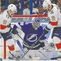  ?? MIKE CARLSON/ GETTY IMAGES ?? Lightning goalie Andrei Vasilevski­y frustrates Sam Reinhart, left, and Aleksander Barkov of the Florida Panthers en route to a shutout win in Game 4 on Monday night in Tampa, Fla.