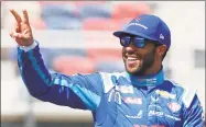  ?? Ralph Freso / Associated Press ?? Bubba Wallace waves to fans during driver introducti­ons prior to the NASCAR Cup Series race at Phoenix Raceway in March in Avondale, Ariz.