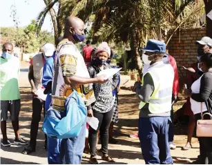  ??  ?? A police officer checks on exemption papers in Harare yesterday