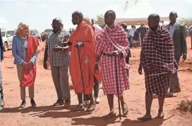  ?? BRIAN INGANGA/AP ?? First Lady Jill Biden, left, greets members of the Maasai community as they explain the drought situation in Kenya, Sunday.