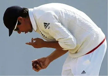  ??  ?? It’s a no-no: England captain alastair Cook polishes the ball during their ashes Test cricket match against australia. a move to ban the use of saliva to shine a cricket ball may force bowlers to relearn or reinvent one of the sport’s most prized skills. — aP