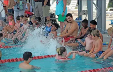  ?? TONY LENAHAN/THE Saline Courier ?? A total of 57 children participat­ed in the World's Largest Swimming Lesson hosted by the city of Bryant Thursday at Bishop Park. The goal of the event was to bring awareness about the importance of teaching children how to swim and water safety.