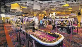  ??  ?? Plexiglass will keep visitors separated at slots and table games in the main gambling area of Virgin Hotels Las Vegas.