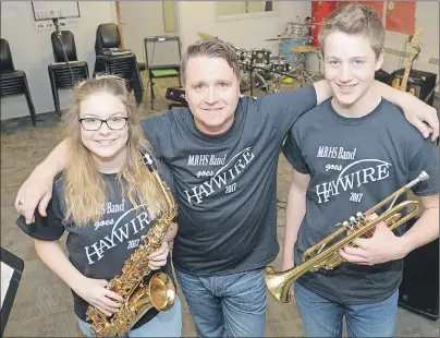  ?? MITCH MACDONALD/THE GUARDIAN ?? Montague Regional High School (MRHS) students Sam Martell, left, and Merlin M’Cloud, right, along with music teacher Kirk White get ready to rock at the MRHS Band Goes Haywire concert being held at the school next Tuesday. The concert will see the school’s current performing band collaborat­e with Haywire guitarist Marvin Birt for a version of the Charlottet­own band’s 1987 hit Dance Desire.