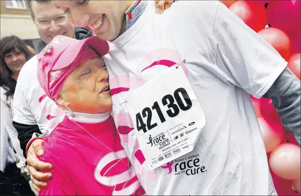  ?? DISPATCH PHOTOS ?? Karee Van Runkle hugs her son Drew at the finish line of the Race for the Cure. Her husband, Pete, is at left.
ERIC ALBRECHT