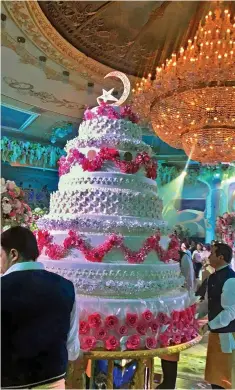  ??  ?? Pricey slice: The wedding cake cost around £150,000