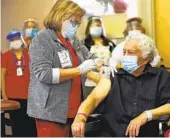  ?? K.C. ALFRED U-T ?? Licensed vocational nurse Virginia Vivar gives a COVID-19 vaccine shot to Carlos Alegre, 72, a resident of Birch Patrick Skilled Nursing Facility.