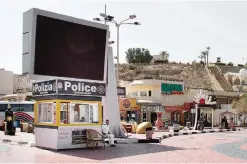  ??  ?? SHARM EL-SHEIKH: A policeman sits under shade in front of a tourism police station in Naama Bay, Sharm El-Sheikh, South Sinai, Egypt yesterday.