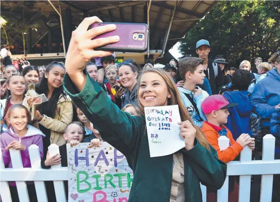  ?? Picture: WARREN LYNAM ?? Bindi Irwin takes a selfie with fans during her 19th birthday celebratio­ns at Australia Zoo yesterday.