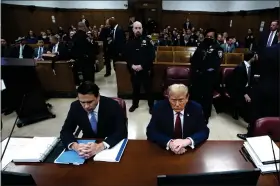  ?? TIMOTHY A. CLARY — POOL VIA AP ?? Former US President Donald Trump, right, sitting next to lawyer Todd Blanche, attends his trial for allegedly covering up hush money payments linked to extramarit­al affairs, at Manhattan Criminal Court in New York City, Tuesday.