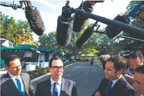  ?? THE ASSOCIATED PRESS ?? Treasury Secretary Steve Mnuchin talks with reporters outside the White House Monday about trade with China.