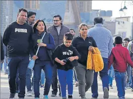  ??  ?? ■ Tourists flock The Ridge on a sunny day in Shimla on Saturday. The maximum temperatur­e was recorded at 19.4 °C. DEEPAK SANSTA/HT