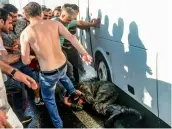  ?? — AFP, Reuters — AP ?? People kick and beat a Turkish soldier, who participat­ed in the attempted coup, on Istanbul’s Bosphorus Bridge on Saturday.