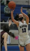  ?? KEN SWART — FOR MEDIANEWS GROUP ?? Royal Oak’s Sarah Soraghan (13) shoots for two of her team-high 18points as Berkley’s Sammi Withrow defends during the OAA Red/Blue crossover match-up played on Friday at Royal Oak High School. The Ravens defeated the Bears 52-40.