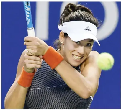  ??  ?? Garbine Muguruza of Spain hits a return against Monica Puig of Puerto Rico during their women’s singles second round match at the Pan Pacific Open tennis tournament in Tokyo on Wednesday. (AFP)