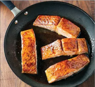  ?? The Associated Press ?? This photo provided by America's Test Kitchen shows honey-lime glazed roast salmon in Brookline, Mass. This recipe appears in the cookbook “How to Roast Everything”.