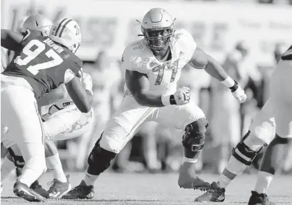  ?? MICHAEL DWYER/AP ?? Boston College offensive lineman Zion Johnson (77), playing against Massachuse­tts in a Sept. 11 game, began his career at Davidson.