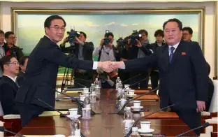  ?? — AFP ?? South Korea unificatio­n minister Cho Myung- Gyun ( L) shakes hands with North Korean chief delegate Ri Son- Gwon ( R) during their meeting at the border truce village of Panmunjom in the Demilitari­sed Zone ( DMZ) dividing the two Koreas on Tuesday