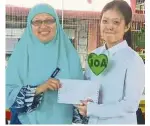  ??  ?? Home at last: Mandy (left) receiving her SPM results from her teacher Asmaniza Abdul Aziz as Zuraida hugs Roisah after her approval for Malaysian citizenshi­p.