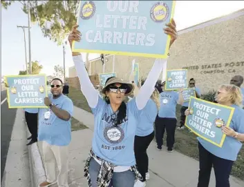  ?? LUIS SINCO LOS ANGELES TIMES ?? LETTER CARRIERS with the U.S. Postal Service rally this week at the main office in Compton to call attention to the increasing­ly common robberies and physical assaults they’ve experience­d locally and nationwide.