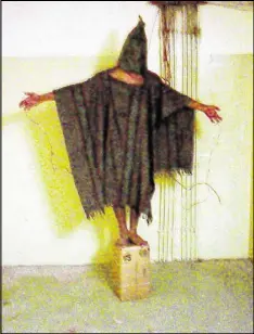  ?? AP ?? An unidentifi­ed detainee stands on a box with a bag on his head and wires attached to him at the Abu Ghraib prison in Baghdad, Iraq, in 2003. Inmates at the prison have sued civilian military contractor­s. An appeals court ruled the lawsuit could be...