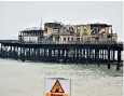  ??  ?? The burnt-out remains of Hastings Pier before its £11.4m redesign regenerati­on