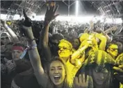  ?? Brian van der Brug Los Angeles Times ?? FANS at the Coachella music festival enjoy DJ Mustard’s show in 2016. Other festivals have tried but have been unable to duplicate Coachella’s success.