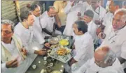  ?? PTI ?? Congress president Rahul Gandhi, along with party leaders and Karnataka chief minister Siddaramai­ah (left), enjoys tea and snacks at Kalamala, 16km from Raichur, on Monday.