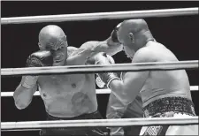  ?? JOE SCARNICI/TRILLER /AP PHOTO ?? In a photo provided by Triller, Mike Tyson throws a punch during the third round against Roy Jones Jr. in an exhibition boxing match on Saturday night in Los Angeles.