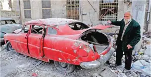  ??  ?? A picture taken on March 9, 2017, shows 70-year-old Mohammad Mohiedine Anis opening the trunk of his 1949 Hudson Commodor outside his home in Aleppo's formerly rebel-held Al-Shaar neighborho­od.