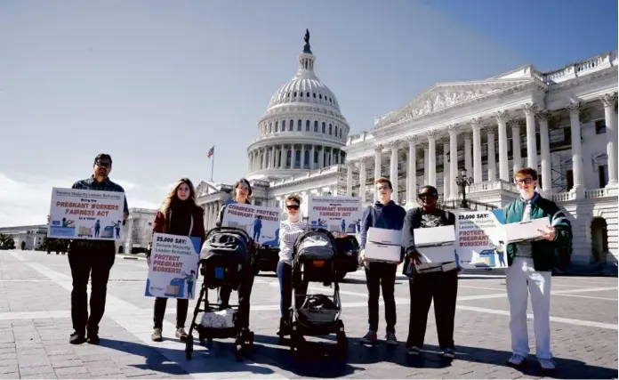  ?? PAUL MORIGI/GETTY IMAGES FOR PARENTSTOG­ETHER ?? PREGNANCY PROTECTION­S — Parents, pregnant women, and children rallied outside the Capitol Wednesday to deliver boxes of petitions urging Congress to bring the Pregnant Workers Fairness Act to a vote.