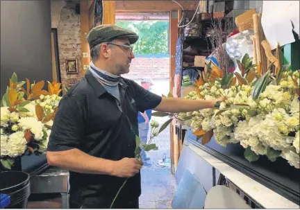  ?? COURTESY PHOTOS ?? Michael Lanni, of Volanni Floral Design inWashingt­on, D.C., who grewup in Sterling Heights, works on a floral display for Supreme Court Justice Ruth Bader Ginsburg’s memorial, an honor and incredible experience he finds hard to describe.