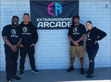  ?? COURTESY OF HAZEL’S HANDS ?? Hazel’s Hands board member Walter Whitehead, from left, Tyrone Spears, president and CEO, William Miller, chief financial officer, and secretary Tai Spears at Extraordin­aire Arcade in San Bernardino in 2023, where the Eastvale-based nonprofit group hosted a back-to-school event, giving shoes and clothing to foster youths.