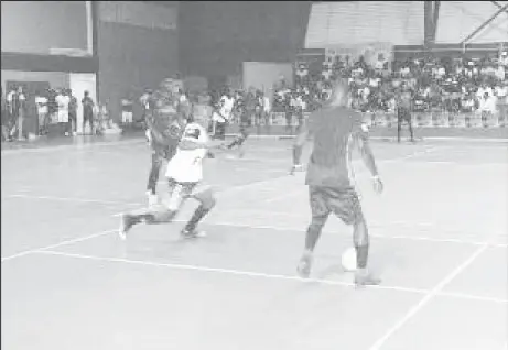  ??  ?? Jermin Junior [center] of Sparta Boss challengin­g Hubert Pedro [right] of Gold is Money for possession of the ball in the 2nd Annual Magnum/Mash Cup Futsal Championsh­ip at the National Gymnasium