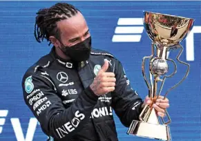  ?? ?? Best of the lot: Lewis Hamilton celebrates on the podium after winning the russian Grand prix at the sochi autodrom circuit on sunday. — afp