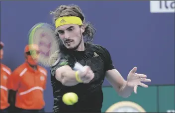  ?? MARTA LAVANDIER ?? STEFANOS TSITSIPAS OF GREECE RETURNS to Damir Dzumhur of Bosnia during the Miami Open tennis tournament Saturday in Miami Gardens, Fla.