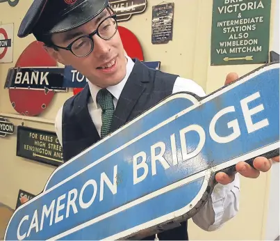  ??  ?? Principal auctioneer Richard Edmonds with the Cameron Bridge sign, one of the items to be sold.