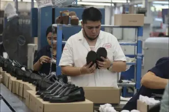  ?? Mario Armas/Associated Press ?? People work in a shoe factory Tuesday in Leon, Mexico, The United States began pressing Mexico over a series of labor rights violations almost two years ago. A subsequent, fair labor vote won a new union an 8.5% wage increase and more bonuses.