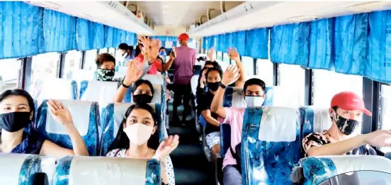  ?? PHOTOGRAPH­S COURTESY OF SBG ?? Following protocol With their masks on and seated apart, locally-stranded individual­s board the bus (inset) that would take them to their respective hometowns as part of the government’s Hatid Tulong program.