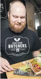  ?? DARREN STONE, TIMES COLONIST ?? James Davison prepares vegan tacos at Very Good Butchers at the Hudson.