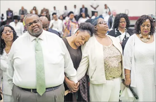  ?? CP PHOTO ?? Members of the Saint Thomas Baptist Church congregati­on are emotional while holding hands during a healing service being held at the North Preston Community Centre in Halifax on Sunday, March 26, 2017 after a fire damaged their church earlier in the...