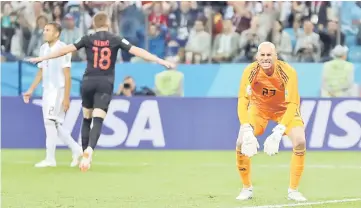  ??  ?? A horrendous error by Argentina goalkeeper Willy Caballero (right) allowed Croatia’s Ante Rebic to drill in a magnificen­t 53rd-minute volley in their Group D match at Nizhny Novgorod Stadium. — Reuters photo