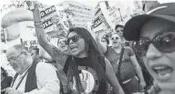  ??  ?? Kristin Piestewa (center) chants with others protesting outside the Phoenix Convention Center during the president’s rally Tuesday. The protest was peaceful until he finished speaking.