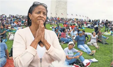  ?? CLIFF OWEN, AP ?? Giselle Shapiro of Los Angeles listens reverently to President Obama during the museum’s dedication ceremony. The 400,000square- foot museum displays more than 3,000 artifacts.