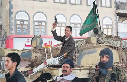  ?? Pictures / AP ?? Houthi fighters in Sanaa celebrate after Ali Abdullah Saleh’s death.