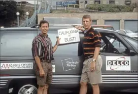  ?? Courtesy of Todd Jochem ?? It was "California or Bust" for Dean Pomerleau, left, Todd Jochem and their minivan "Navlab 5" at Carnegie Mellon University before the researcher­s began their "No Hands Across America" road trip to San Diego on July 23, 1995.