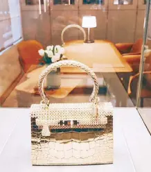  ??  ?? Bag or bracelet: A Pierre Hardy-designed Hermès Kelly made of solid rose gold with 1,160 diamonds is on display at the Landmark Prince’s store.