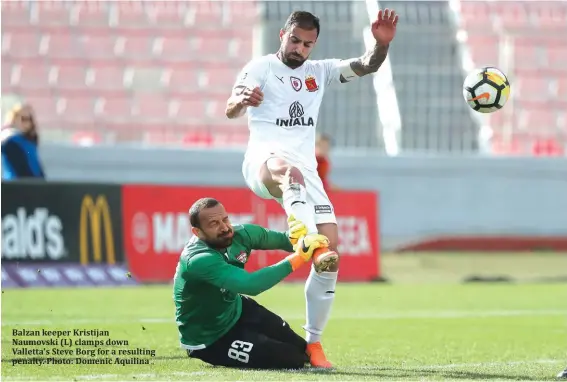  ??  ?? Balzan keeper Kristijan Naumovski (L) clamps down Valletta's Steve Borg for a resulting penalty. Photo: Domenic Aquilina