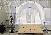  ?? Anne Cusack / Los Angeles Times file ?? Workers take measuremen­ts for a backdrop for a capsule model at Hyperloop Transporta­tion Technologi­es in Culver City, Calif. South by Southwest Interactiv­e will have a session on the system.