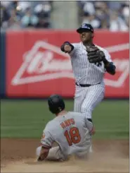  ?? SETH WENIG — THE ASSOCIATED PRESS ?? New York Yankees second baseman Starlin Castro, top, turns a double play over Baltimore Orioles’ Austin Hays during the sixth inning of a baseball game at Yankee Stadium, Sunday in New York.